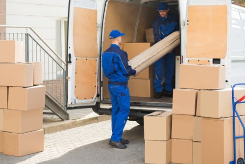 Removal team preparing a Kensington home move with furniture protection